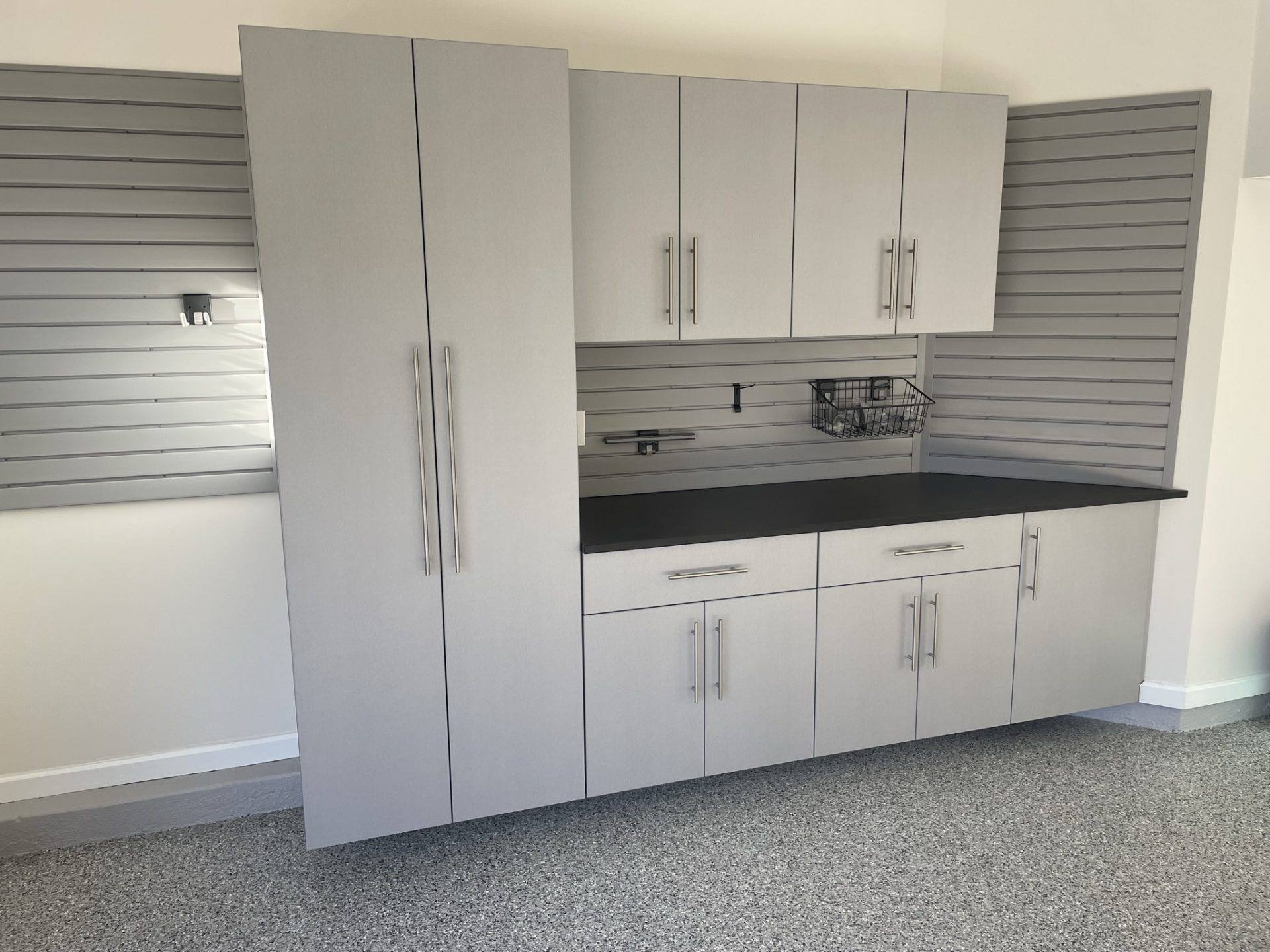 Custom angled wall cabinets in Silver Frost with gray slatwall detail