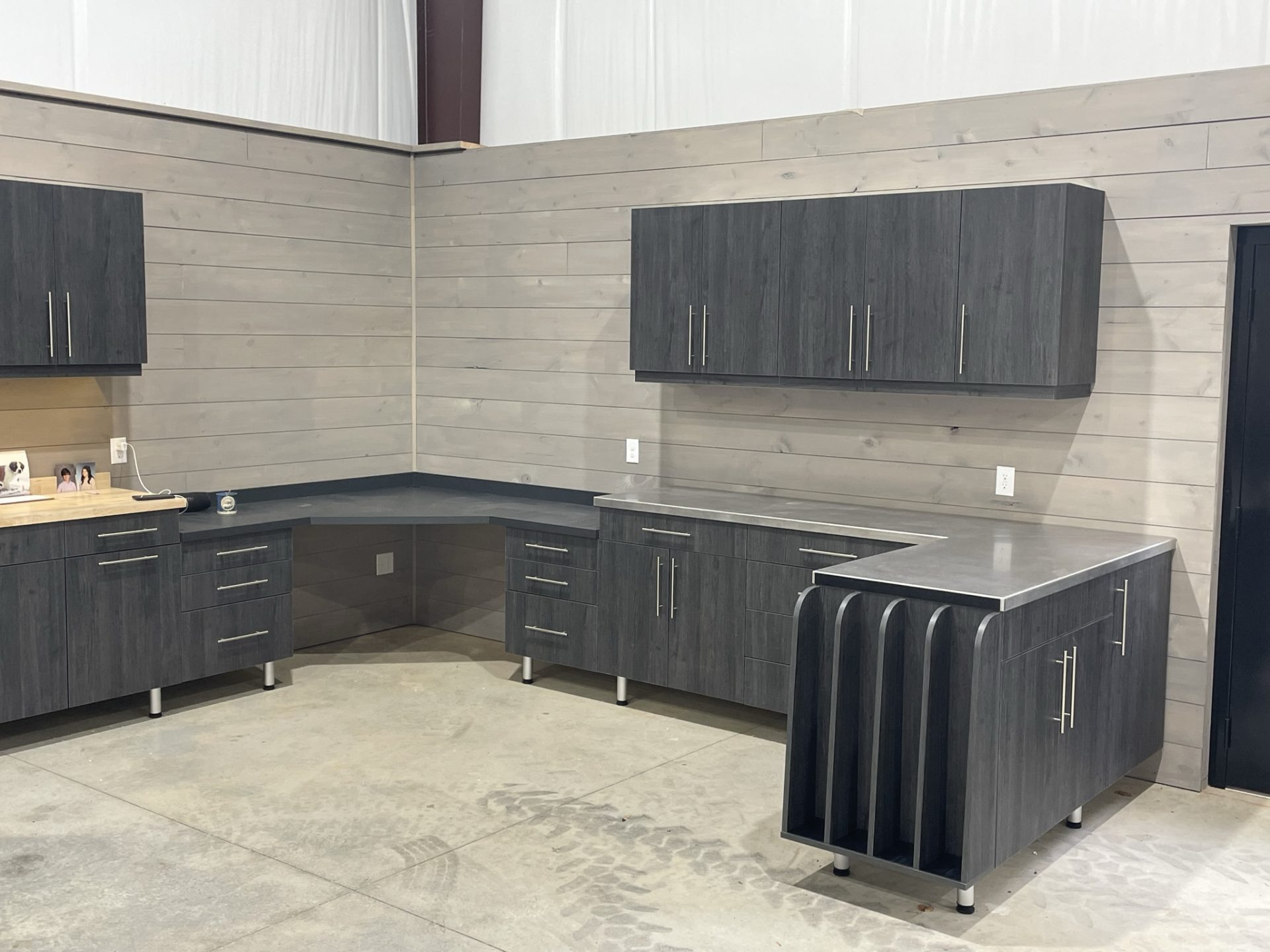custom garage cabinets upper and lower with custom countertop and gun storage at end